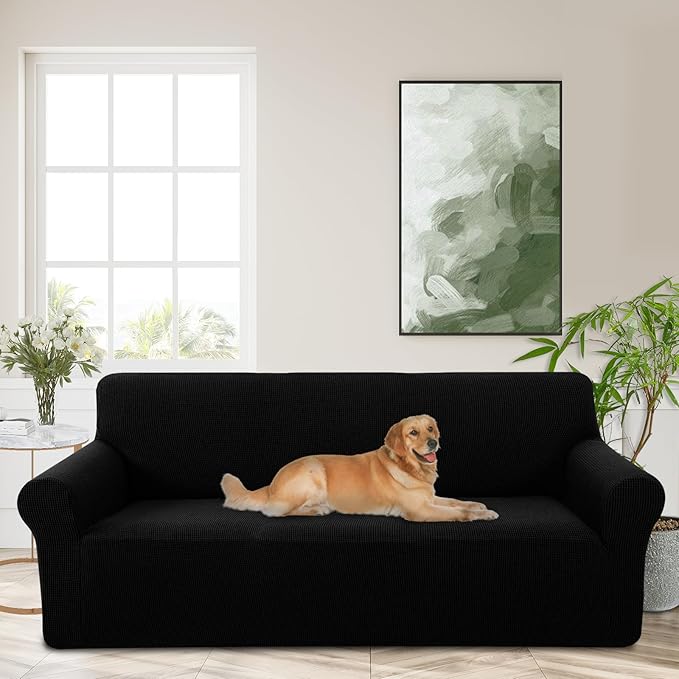 Black stretchable washable couch cover with elastic bottom and foam sticks, designed for large sofas, kids, and pet-friendly protection.